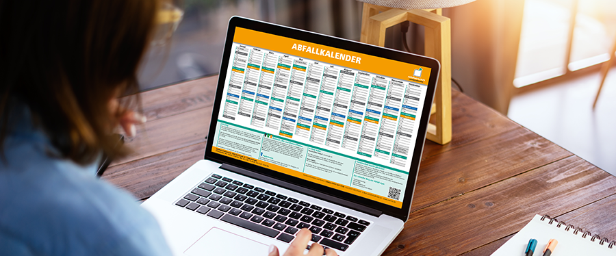 Aufgeklappter Laptop mit Abfallkalender im Bildschirm.
